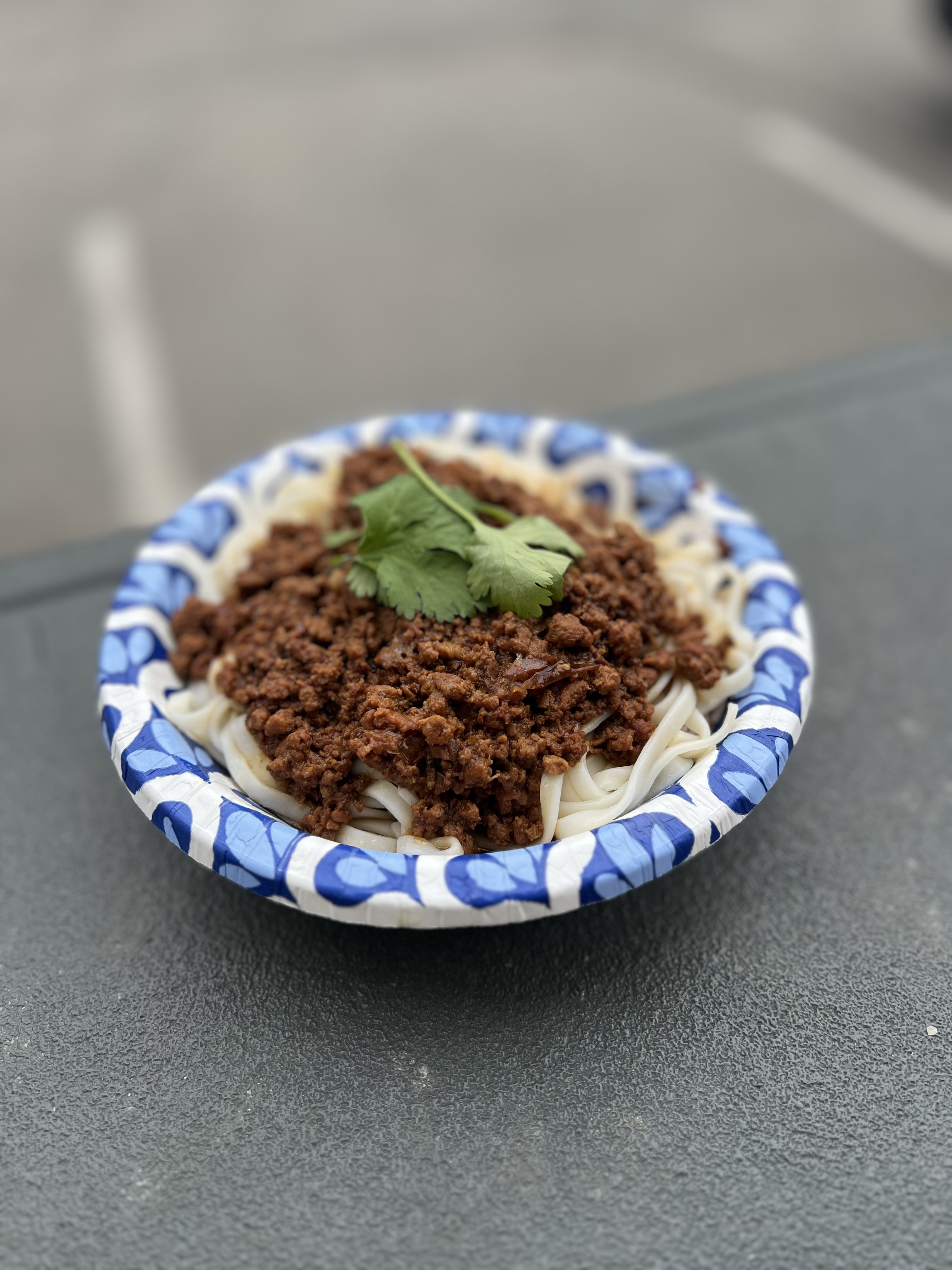 Minced pork stew over noodles